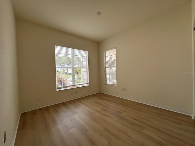 empty room with light hardwood / wood-style flooring