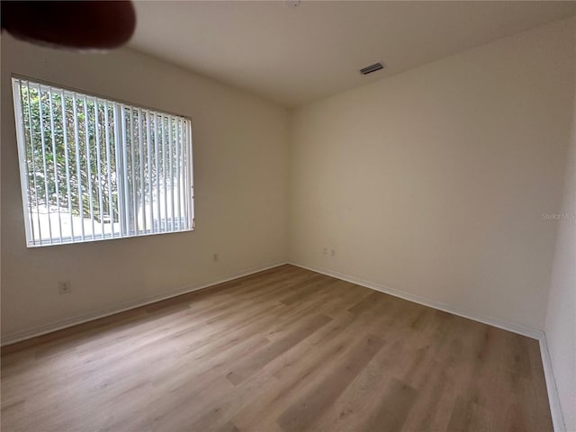 unfurnished room with light hardwood / wood-style floors