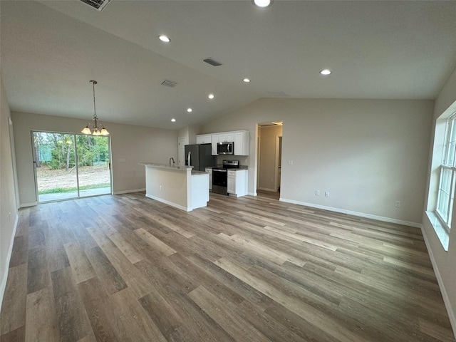 unfurnished living room with lofted ceiling, a notable chandelier, and light hardwood / wood-style floors