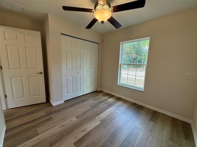 unfurnished bedroom with a closet, ceiling fan, and light hardwood / wood-style flooring