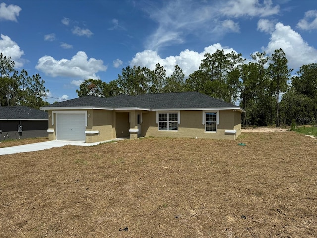 ranch-style house with a garage and a front lawn