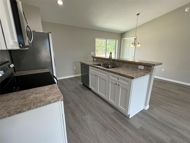 kitchen featuring white cabinetry, appliances with stainless steel finishes, pendant lighting, and an island with sink