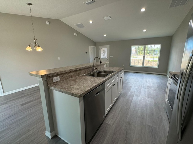 kitchen featuring sink, dishwasher, white cabinets, a center island with sink, and decorative light fixtures