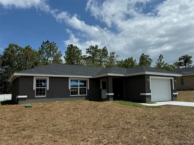 single story home with a garage and a front yard