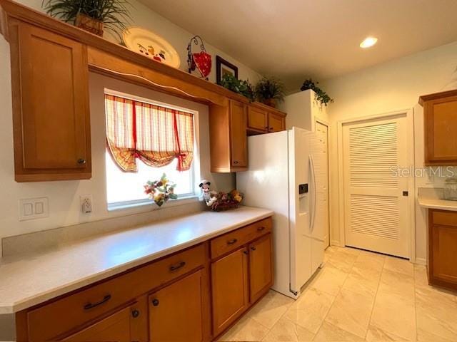 kitchen with white fridge with ice dispenser