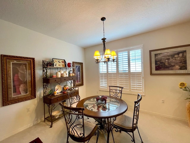 dining space with an inviting chandelier, a textured ceiling, and carpet flooring