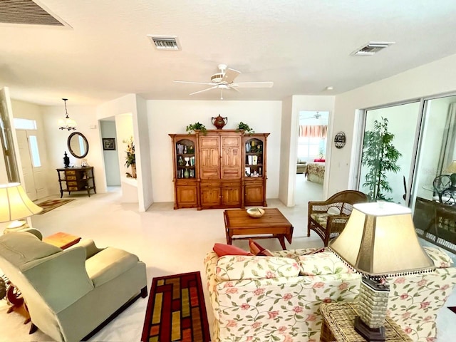 living room featuring light colored carpet and ceiling fan