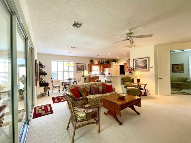 carpeted living room featuring a textured ceiling and ceiling fan