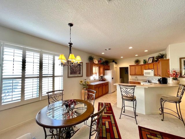 dining area with a textured ceiling and a chandelier