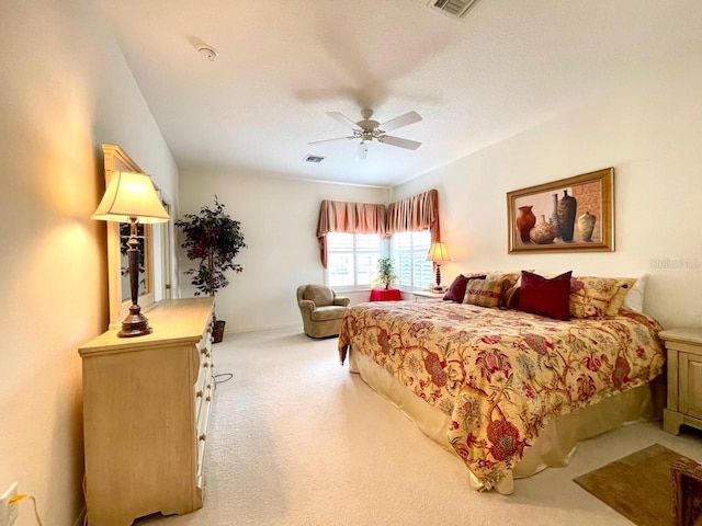 bedroom featuring ceiling fan and light colored carpet