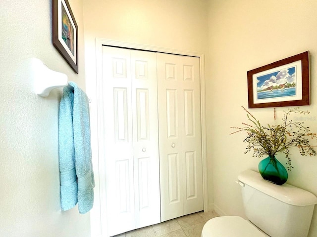 bathroom featuring toilet and tile patterned flooring