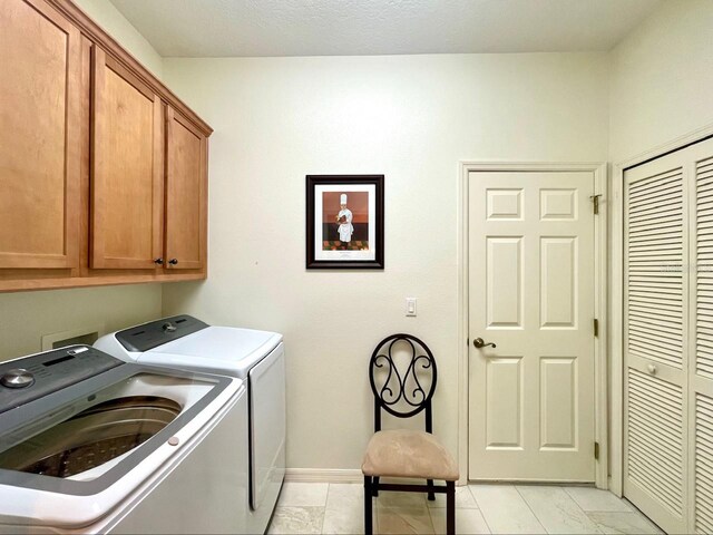 laundry room with cabinets and washer and dryer