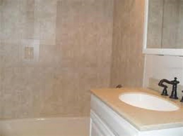 bathroom with vanity and tub / shower combination