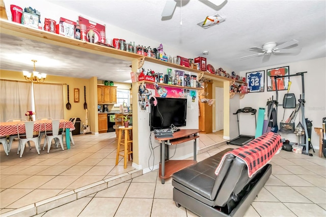 interior space with light tile floors, a textured ceiling, and ceiling fan with notable chandelier