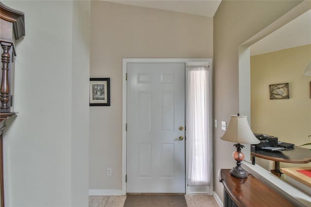 tiled foyer featuring lofted ceiling