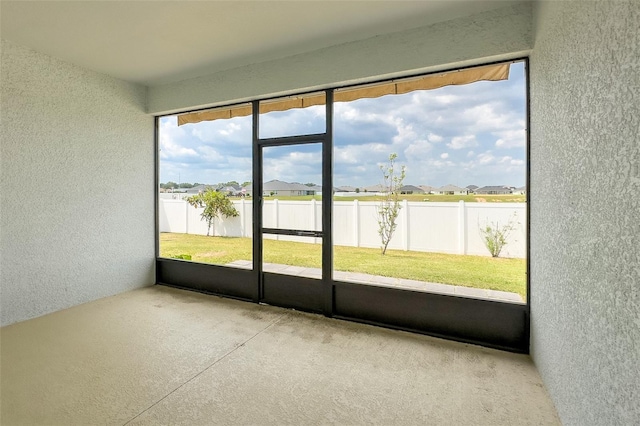 unfurnished sunroom featuring plenty of natural light