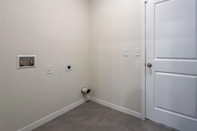 washroom with hookup for an electric dryer, dark tile flooring, and hookup for a washing machine