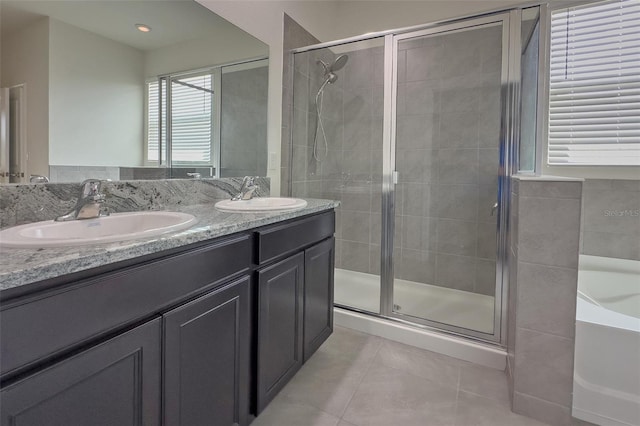 bathroom featuring plus walk in shower, tile floors, and dual vanity