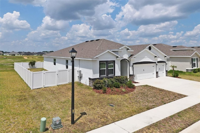 view of front of house featuring a front yard and a garage