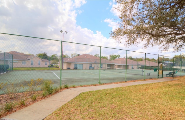 view of sport court with a yard