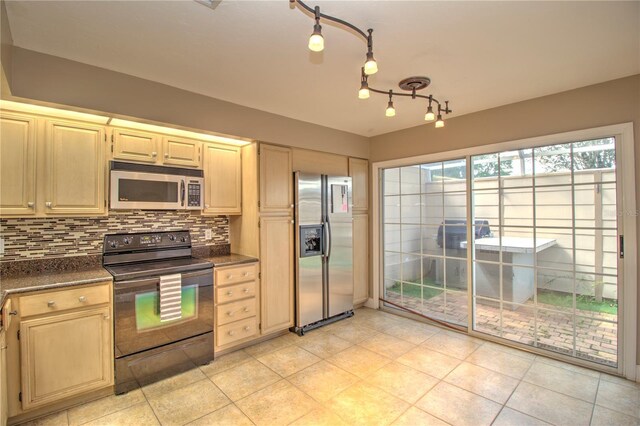 kitchen featuring light tile patterned floors, appliances with stainless steel finishes, and decorative backsplash