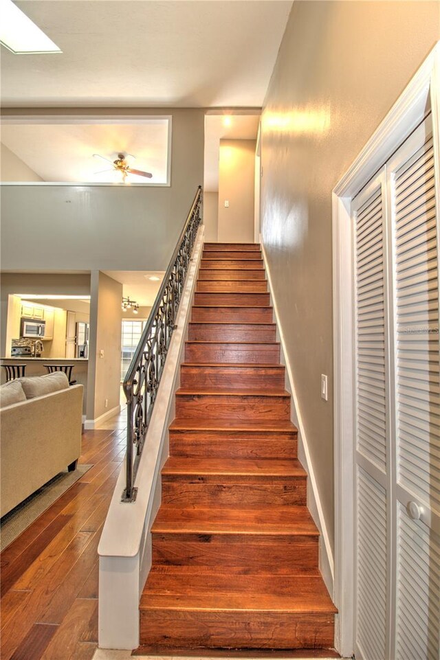 stairs featuring hardwood / wood-style floors