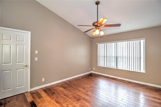 spare room with lofted ceiling, wood-type flooring, and ceiling fan