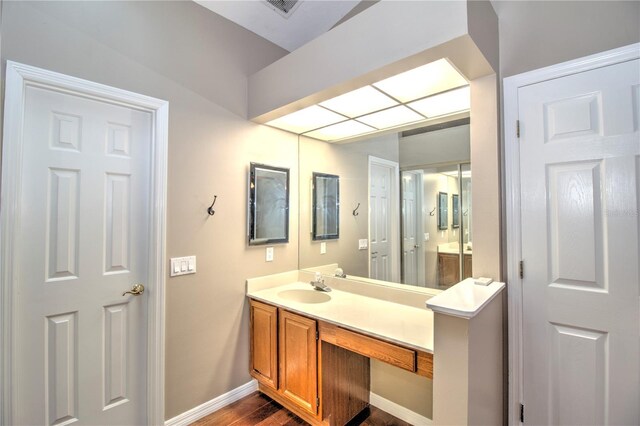 bathroom featuring vanity and hardwood / wood-style flooring