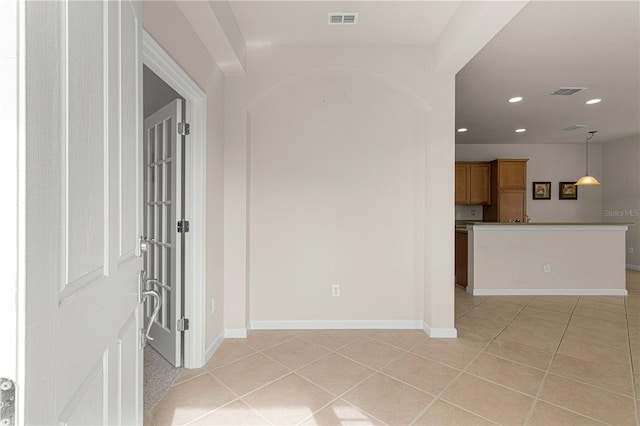 corridor featuring light tile patterned floors