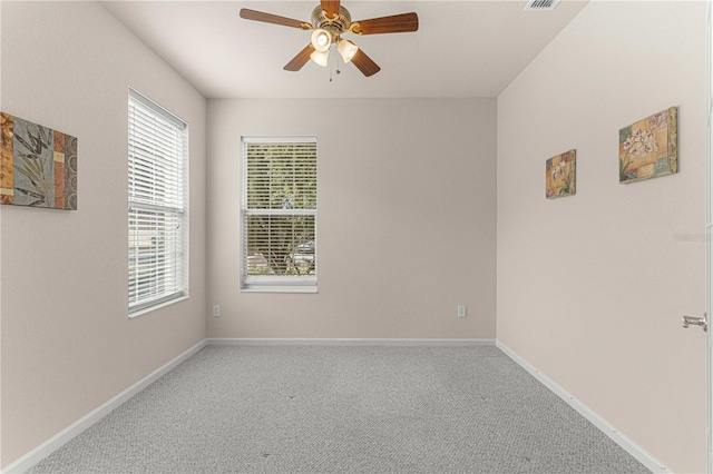 empty room with plenty of natural light, carpet floors, and ceiling fan