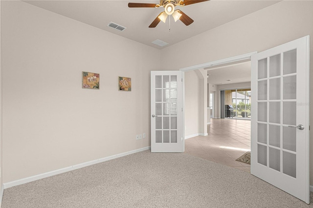 unfurnished room with light carpet, french doors, and ceiling fan