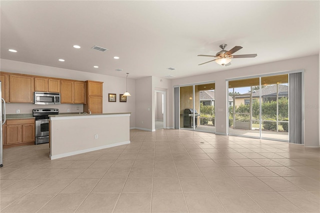 kitchen featuring light tile patterned floors, a center island, ceiling fan, range with electric cooktop, and pendant lighting