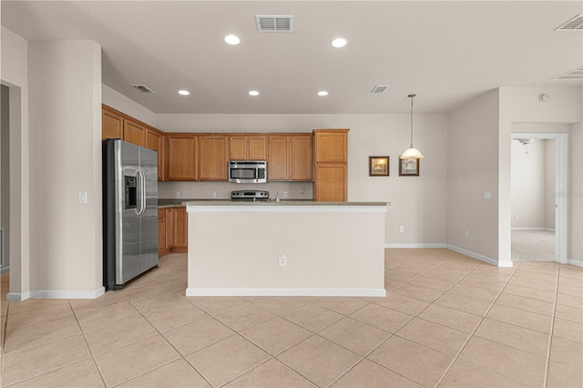 kitchen featuring a kitchen island with sink, light carpet, hanging light fixtures, and appliances with stainless steel finishes