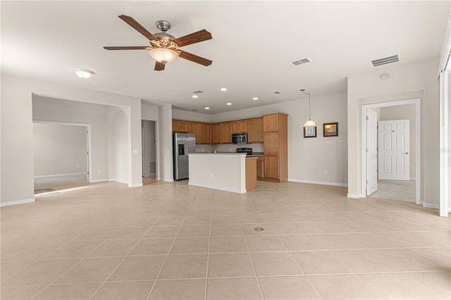 unfurnished living room featuring ceiling fan and light tile patterned floors