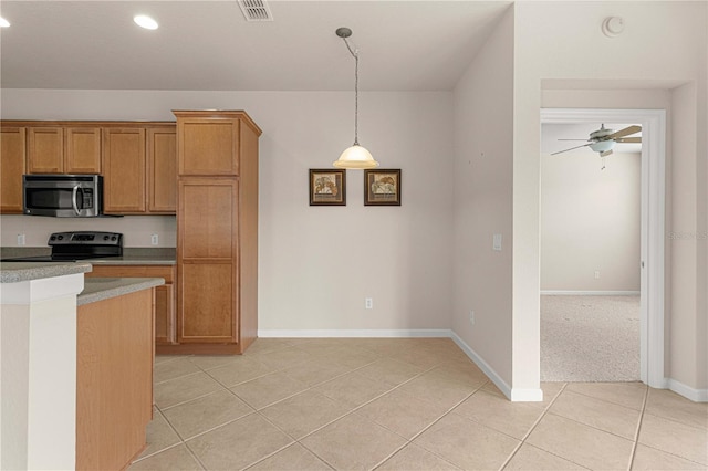 kitchen featuring hanging light fixtures, ceiling fan, stainless steel appliances, and light colored carpet