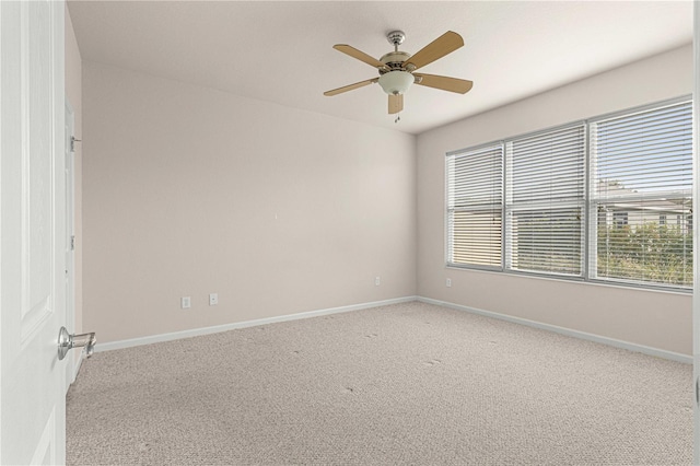 carpeted empty room featuring ceiling fan