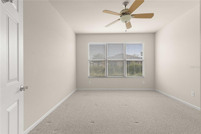 spare room with carpet and ceiling fan