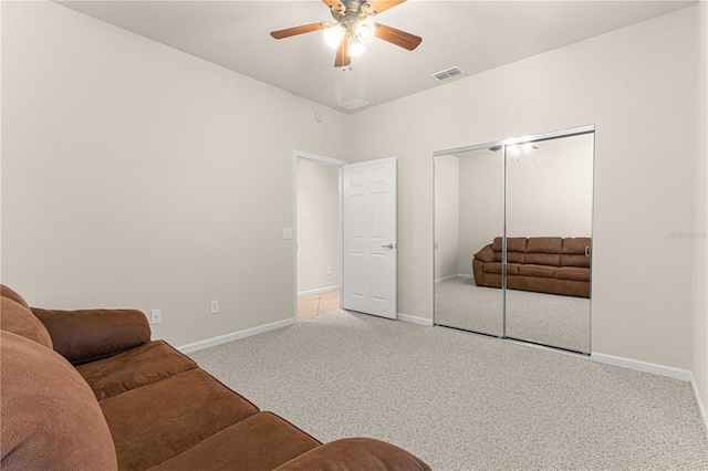 living room featuring ceiling fan and carpet flooring