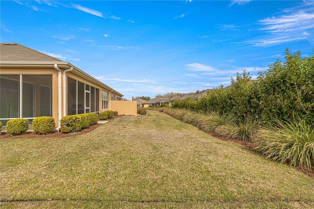 view of yard featuring a sunroom