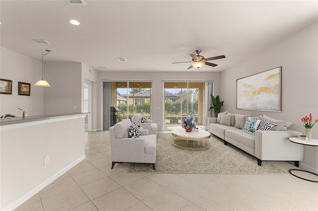 tiled living room featuring sink and ceiling fan