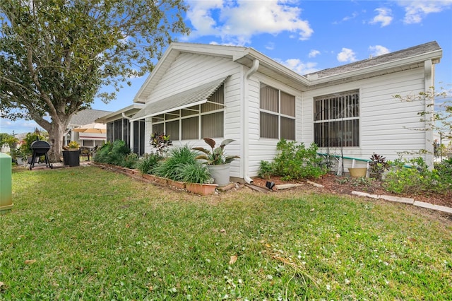 view of home's exterior with a lawn