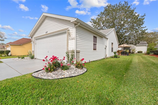 view of side of home with a lawn and a garage