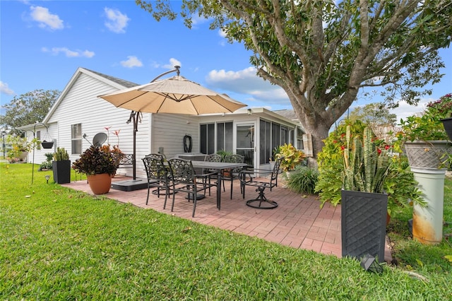 back of property featuring a lawn and a patio