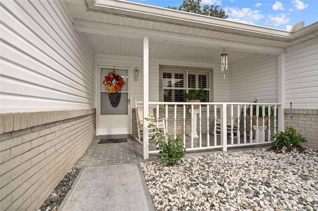 doorway to property featuring covered porch