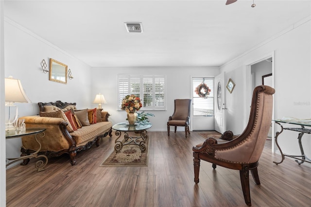 living room featuring crown molding and dark hardwood / wood-style flooring