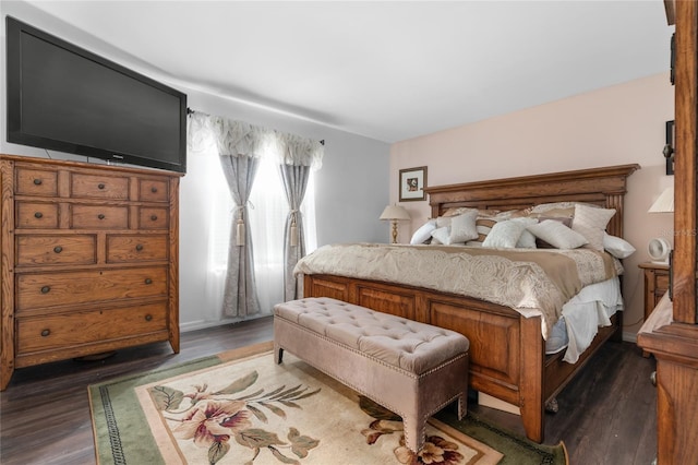 bedroom with dark hardwood / wood-style flooring