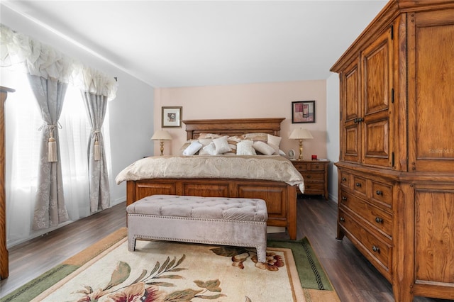 bedroom with dark wood-type flooring