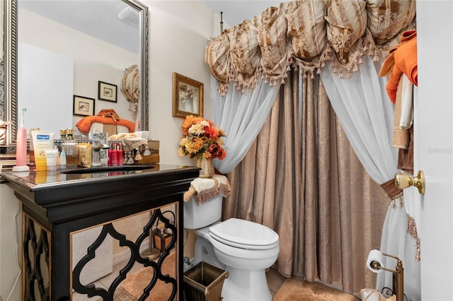 bathroom with toilet and large vanity