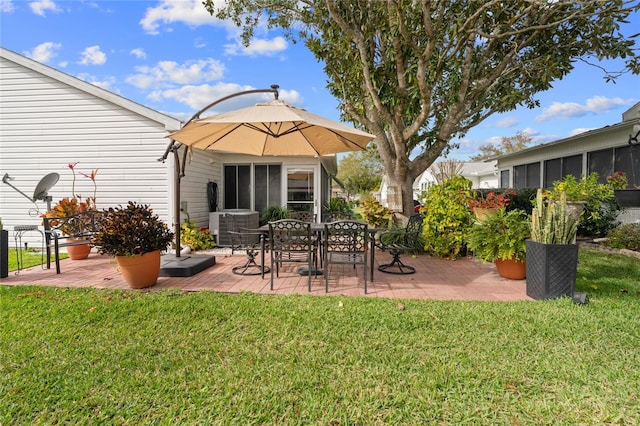 back of property with a lawn and a patio area