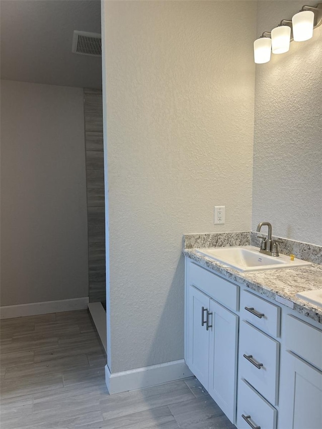 bathroom with hardwood / wood-style flooring and vanity